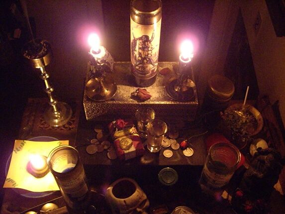 Burning candle amulets and coins for success