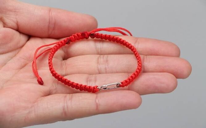 Red thread that protects from evil (left wrist) and attracts happiness (right wrist)
